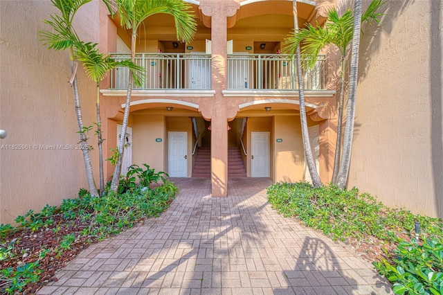 6440 NW 114th Ave Unit 434, Doral, FL 33178 - view of exterior entry featuring a balcony and stucco siding