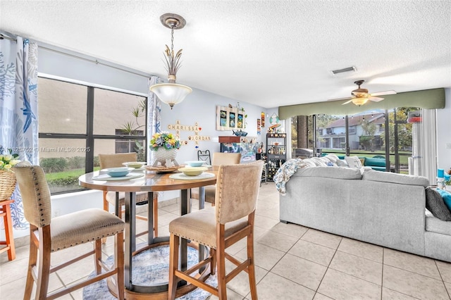 4552 Carambola Cir S Unit 27247, Coconut Creek, FL 33066 - dining area featuring a textured ceiling, a ceiling fan, and light tile patterned floors