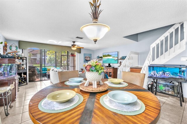 4552 Carambola Cir S Unit 27247, Coconut Creek, FL 33066 - dining space featuring stairway, light tile patterned floors, a textured ceiling, and a ceiling fan