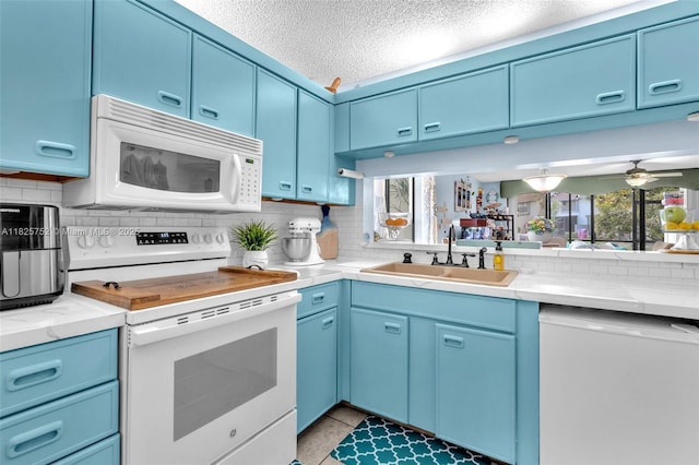 4552 Carambola Cir S Unit 27247, Coconut Creek, FL 33066 - kitchen featuring white appliances, blue cabinets, tasteful backsplash, a textured ceiling, and a ceiling fan