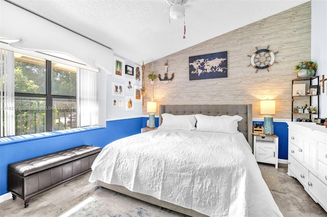 4552 Carambola Cir S Unit 27247, Coconut Creek, FL 33066 - bedroom featuring wood walls, lofted ceiling, a textured ceiling, an accent wall, and ceiling fan