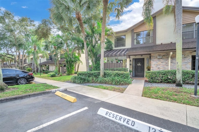 4552 Carambola Cir S Unit 27247, Coconut Creek, FL 33066 - view of front of house featuring uncovered parking and stucco siding