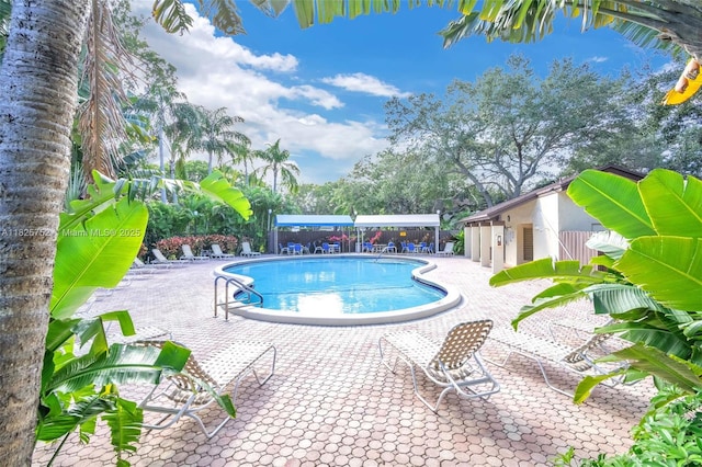 4552 Carambola Cir S Unit 27247, Coconut Creek, FL 33066 - community pool featuring a patio area