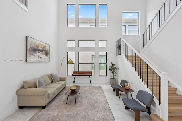 20273 Bandon Dunes Rd, Boca Raton, FL 33434 - living area with stairs, a towering ceiling, and marble finish flooring