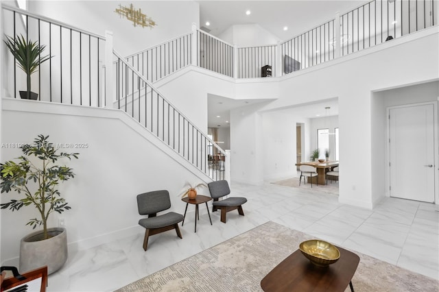 20273 Bandon Dunes Rd, Boca Raton, FL 33434 - living room with marble finish flooring, stairs, a towering ceiling, and recessed lighting