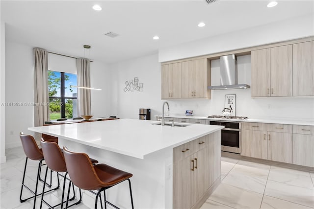 20273 Bandon Dunes Rd, Boca Raton, FL 33434 - kitchen with wall chimney range hood, appliances with stainless steel finishes, light marble finish floors, light brown cabinetry, and recessed lighting