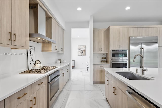 20273 Bandon Dunes Rd, Boca Raton, FL 33434 - kitchen with light brown cabinets, wall chimney range hood, appliances with stainless steel finishes, light marble finish floors, and light countertops