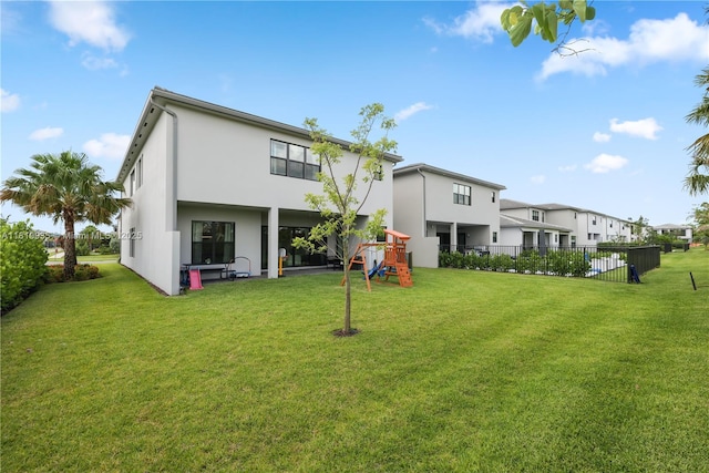 20273 Bandon Dunes Rd, Boca Raton, FL 33434 - rear view of property featuring a playground, stucco siding, and a residential view