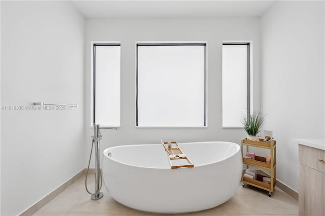 20273 Bandon Dunes Rd, Boca Raton, FL 33434 - bathroom featuring a soaking tub, vanity, and tile patterned floors