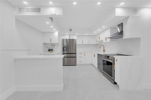 1201 S Ocean Dr Unit 507S, Hollywood, FL 33019 - kitchen featuring wall chimney exhaust hood, appliances with stainless steel finishes, modern cabinets, white cabinetry, and light countertops