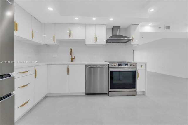 1201 S Ocean Dr Unit 507S, Hollywood, FL 33019 - kitchen with wall chimney exhaust hood, stainless steel appliances, white cabinetry, light countertops, and recessed lighting