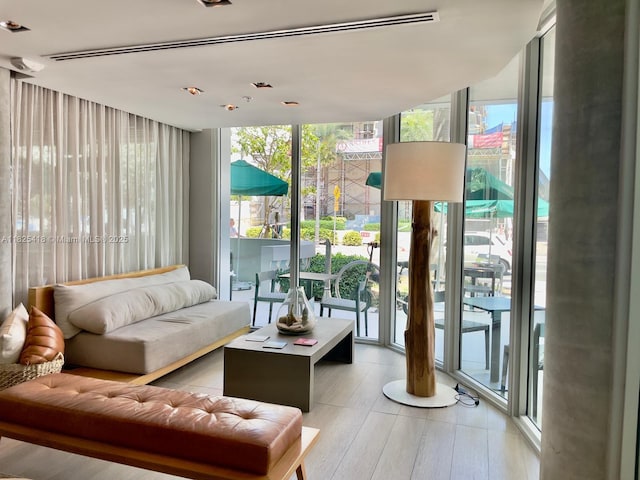 6080 Collins Ave Unit 506, Miami Beach, FL 33140 - living room with floor to ceiling windows and light wood finished floors