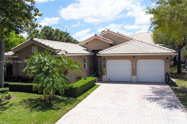 10989 NW 73rd Ter, Doral, FL 33178 - view of front of property with a garage, stucco siding, driveway, and a tile roof