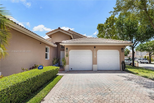10989 NW 73rd Ter, Doral, FL 33178 - view of front facade with decorative driveway, stucco siding, a garage, and a tile roof