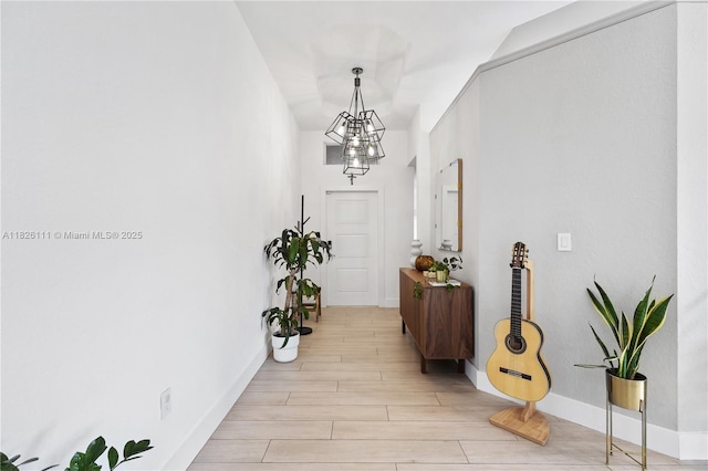 10989 NW 73rd Ter, Doral, FL 33178 - hall with a chandelier and light wood-style flooring