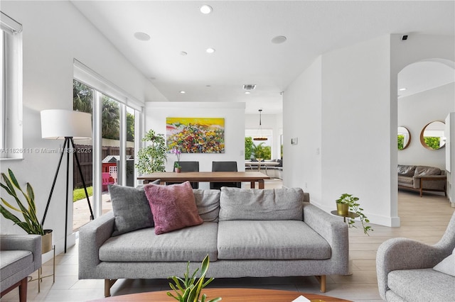 10989 NW 73rd Ter, Doral, FL 33178 - living room with recessed lighting, arched walkways, and light wood-type flooring