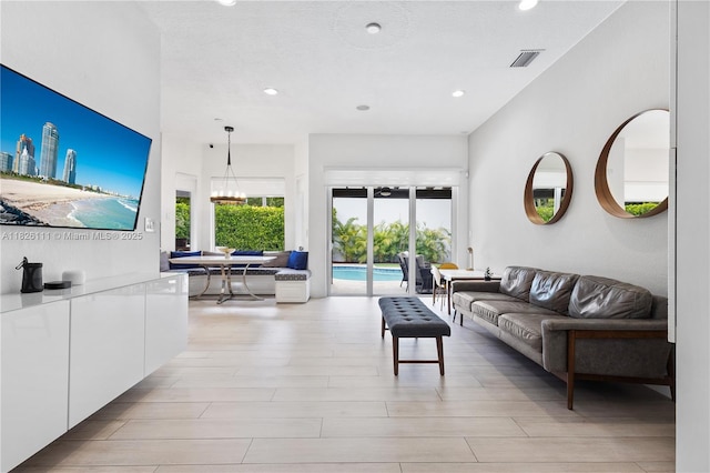 10989 NW 73rd Ter, Doral, FL 33178 - living room featuring recessed lighting, light wood-style flooring, and a chandelier