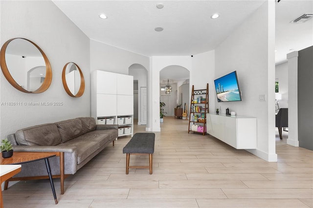 10989 NW 73rd Ter, Doral, FL 33178 - living area with light wood finished floors, arched walkways, recessed lighting, and a chandelier