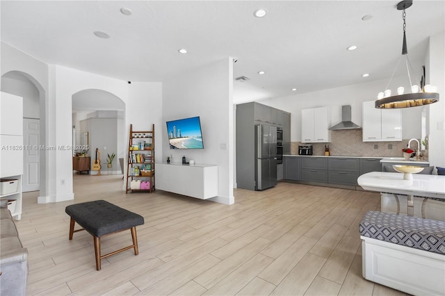 10989 NW 73rd Ter, Doral, FL 33178 - living area with arched walkways, light wood-type flooring, and recessed lighting