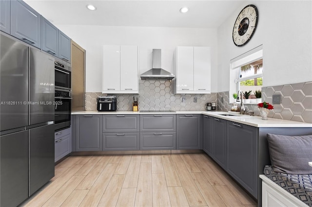 10989 NW 73rd Ter, Doral, FL 33178 - kitchen with freestanding refrigerator, wall chimney range hood, gray cabinetry, light countertops, and recessed lighting