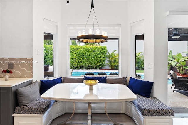 10989 NW 73rd Ter, Doral, FL 33178 - dining room with breakfast area, a chandelier, and a high ceiling
