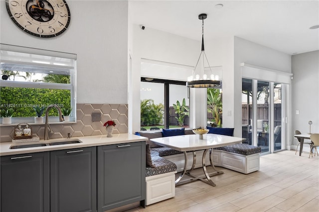 10989 NW 73rd Ter, Doral, FL 33178 - kitchen with breakfast area, tasteful backsplash, a chandelier, and healthy amount of natural light