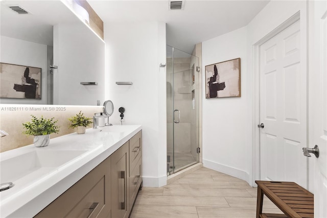 10989 NW 73rd Ter, Doral, FL 33178 - bathroom with a shower stall, double vanity, and wood finished floors