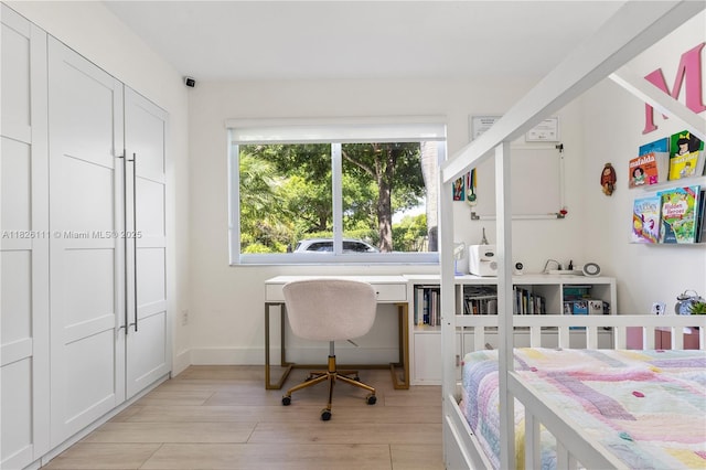 10989 NW 73rd Ter, Doral, FL 33178 - bedroom featuring light wood finished floors and baseboards