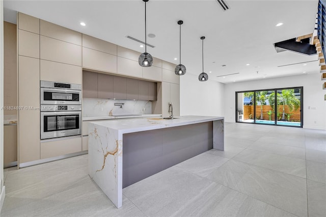 23 SE 12th Ave Unit A, Fort Lauderdale, FL 33301 - kitchen with modern cabinets, double oven, decorative backsplash, recessed lighting, and a spacious island