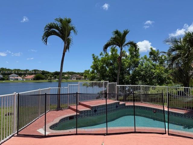 7964 La Rose Ct, Lake Worth, FL 33467 - view of pool with a fenced backyard, a water view, and a patio area