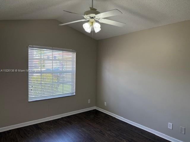 7964 La Rose Ct, Lake Worth, FL 33467 - spare room with dark wood-style flooring, a textured ceiling, a ceiling fan, and vaulted ceiling
