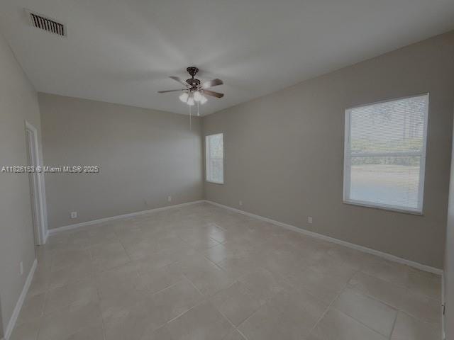 4390 NW 41st Pl, Coconut Creek, FL 33073 - empty room featuring a ceiling fan and light tile patterned floors