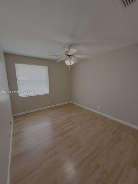 4390 NW 41st Pl, Coconut Creek, FL 33073 - empty room featuring a ceiling fan and light wood-style flooring