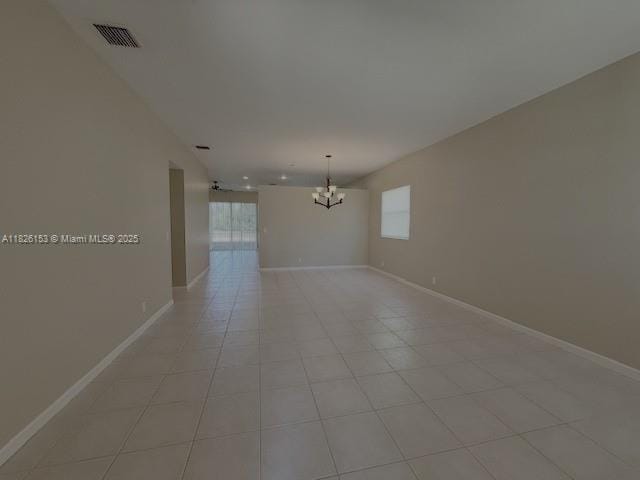 4390 NW 41st Pl, Coconut Creek, FL 33073 - spare room featuring a chandelier, healthy amount of natural light, and light tile patterned flooring