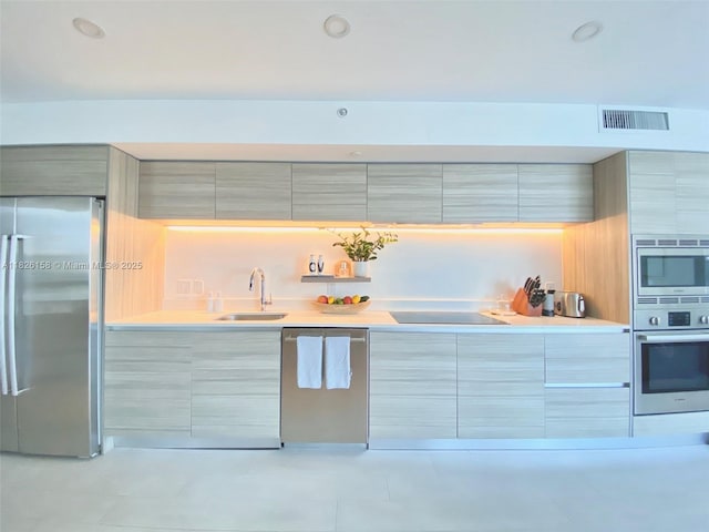6620 Indian Creek Dr Unit 617, Miami Beach, FL 33141 - kitchen with stainless steel appliances, modern cabinets, light tile patterned floors, light countertops, and gray cabinetry