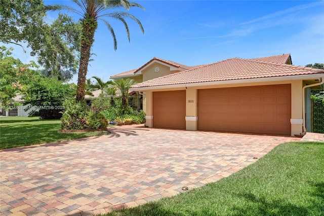 3820 SW 106th Ter, Davie, FL 33328 - mediterranean / spanish house with stucco siding, a tiled roof, an attached garage, a front lawn, and decorative driveway