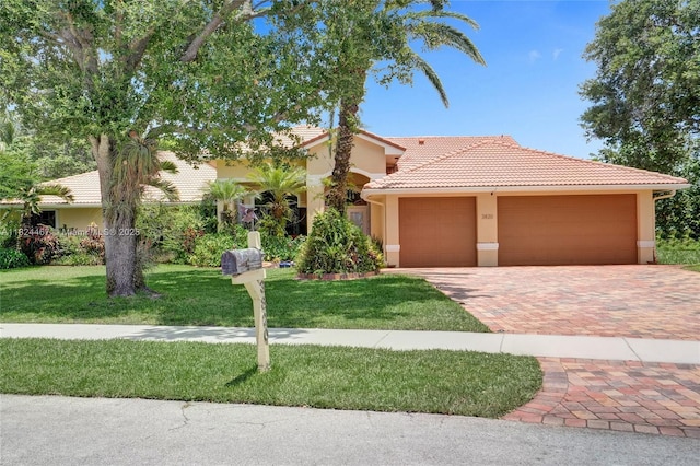 3820 SW 106th Ter, Davie, FL 33328 - mediterranean / spanish home with a tile roof, stucco siding, an attached garage, a front yard, and decorative driveway