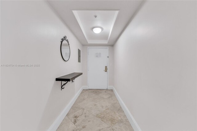 2951 S Bayshore Dr Unit 717, Miami, FL 33133 - doorway to outside featuring a tray ceiling, electric panel, and light marble finish flooring