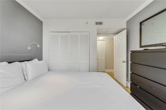2951 S Bayshore Dr Unit 717, Miami, FL 33133 - bedroom featuring ornamental molding, a closet, and light wood-style floors