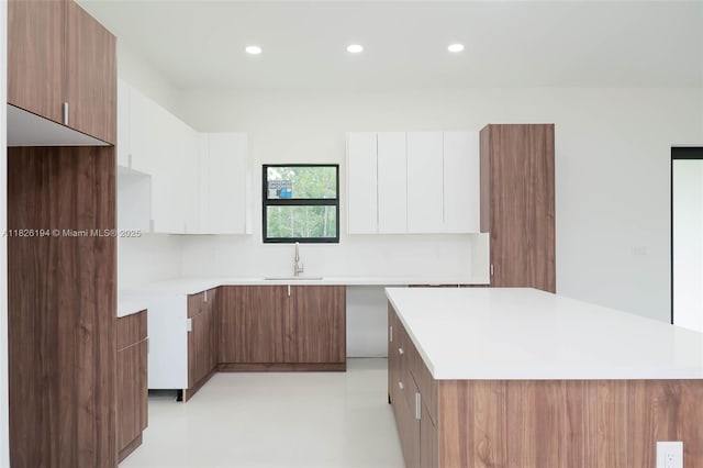 3216 40th St SW, Lehigh Acres, FL 33976 - kitchen with modern cabinets, a center island, white cabinetry, recessed lighting, and brown cabinetry