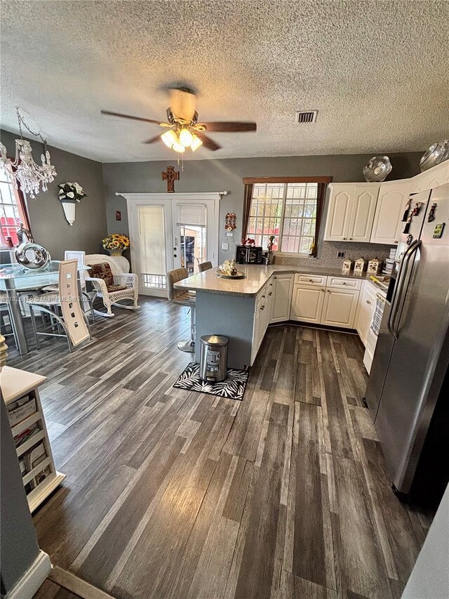 1041 NW 33rd Ave, Miami, FL 33125 - kitchen with stainless steel refrigerator with ice dispenser, a peninsula, dark wood-style floors, a textured ceiling, and a ceiling fan