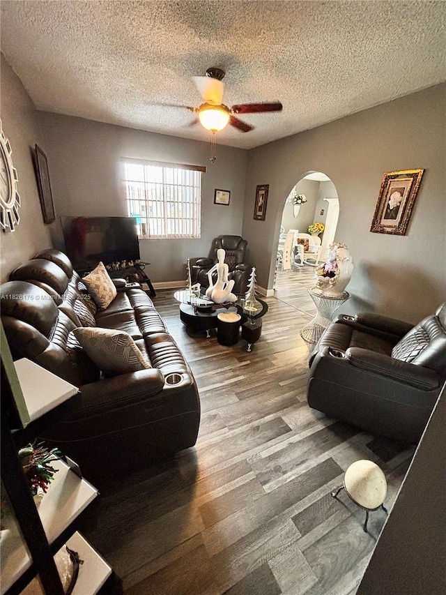 1041 NW 33rd Ave, Miami, FL 33125 - living area featuring arched walkways, ceiling fan, wood finished floors, and a textured ceiling