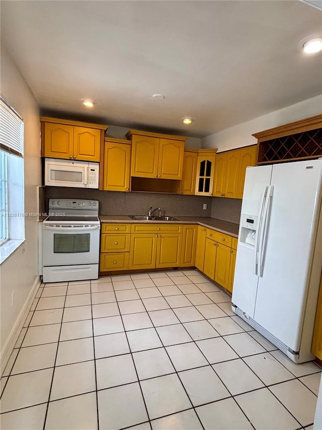 1041 NW 33rd Ave, Miami, FL 33125 - kitchen featuring white appliances, recessed lighting, light tile patterned floors, and glass insert cabinets
