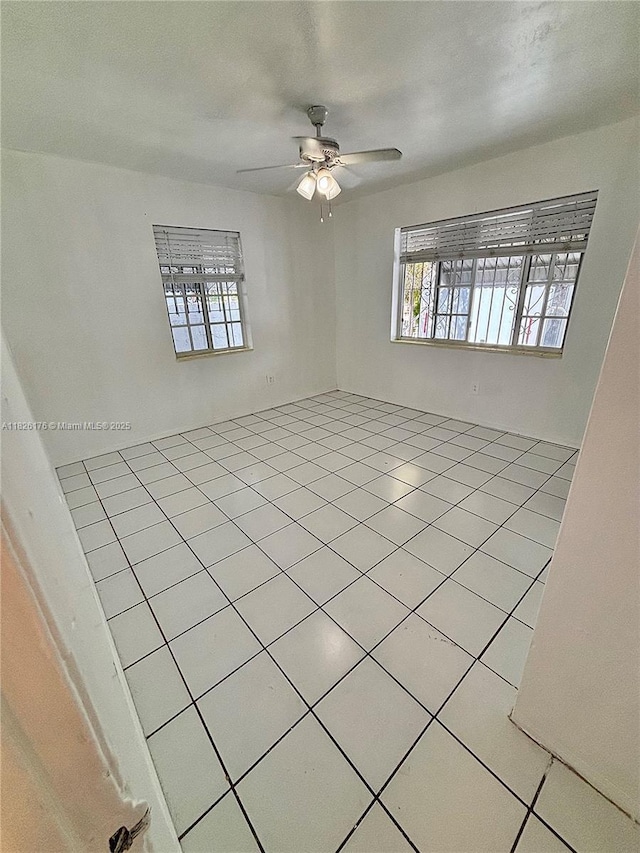 1041 NW 33rd Ave, Miami, FL 33125 - empty room featuring healthy amount of natural light, a ceiling fan, and light tile patterned flooring