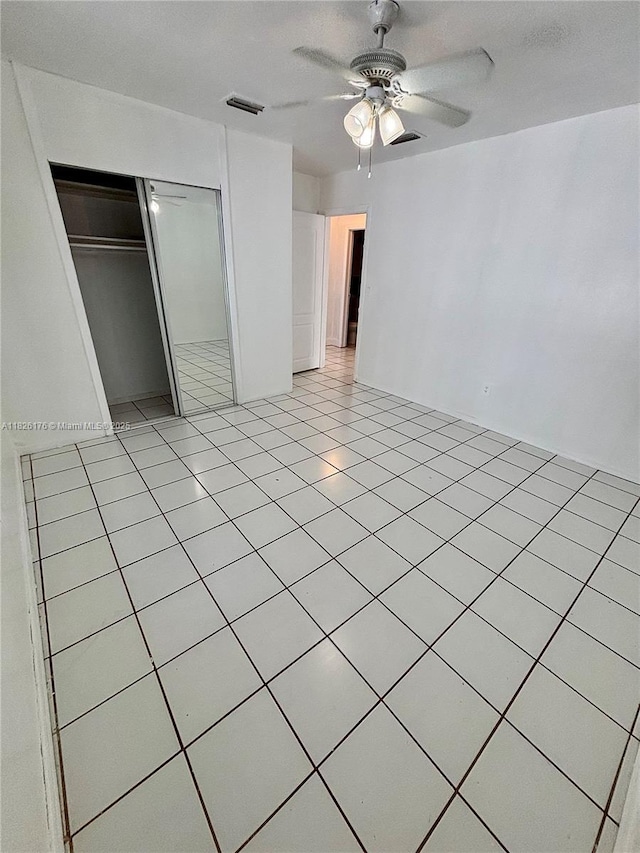 1041 NW 33rd Ave, Miami, FL 33125 - unfurnished bedroom featuring a closet, ceiling fan, and light tile patterned flooring
