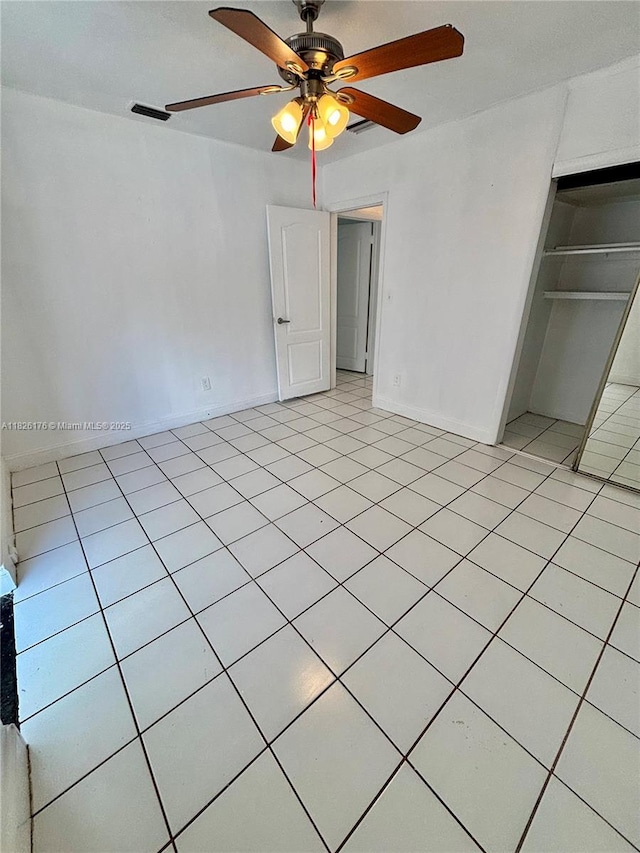 1041 NW 33rd Ave, Miami, FL 33125 - unfurnished bedroom featuring a closet, light tile patterned floors, and a ceiling fan