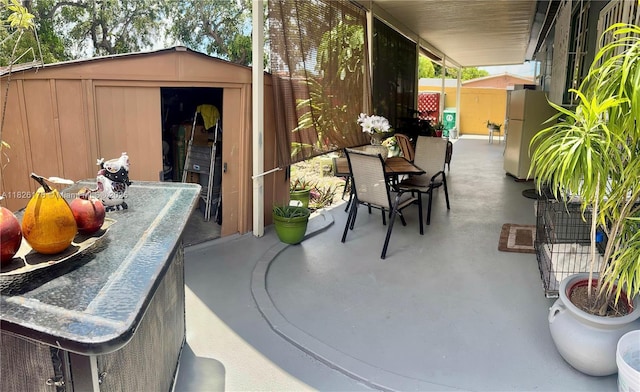 1041 NW 33rd Ave, Miami, FL 33125 - view of patio / terrace featuring a storage shed and outdoor dining space