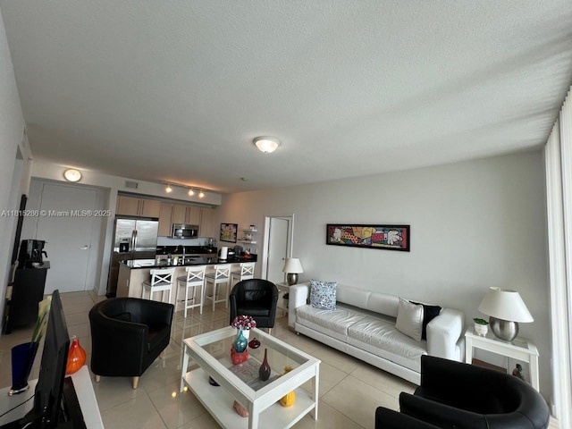 79 SW 12th St Unit 1603-S, Miami, FL 33130 - living room featuring light tile patterned floors and a textured ceiling