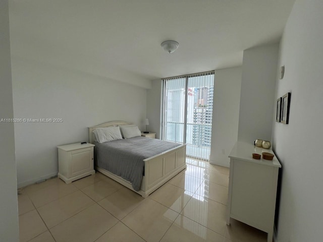 79 SW 12th St Unit 1603-S, Miami, FL 33130 - bedroom featuring light tile patterned floors and expansive windows