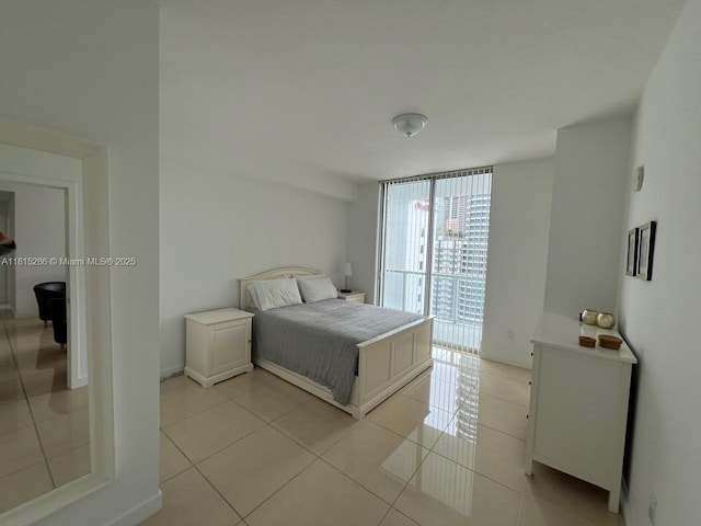79 SW 12th St Unit 1603-S, Miami, FL 33130 - bedroom featuring light tile patterned floors and a wall of windows